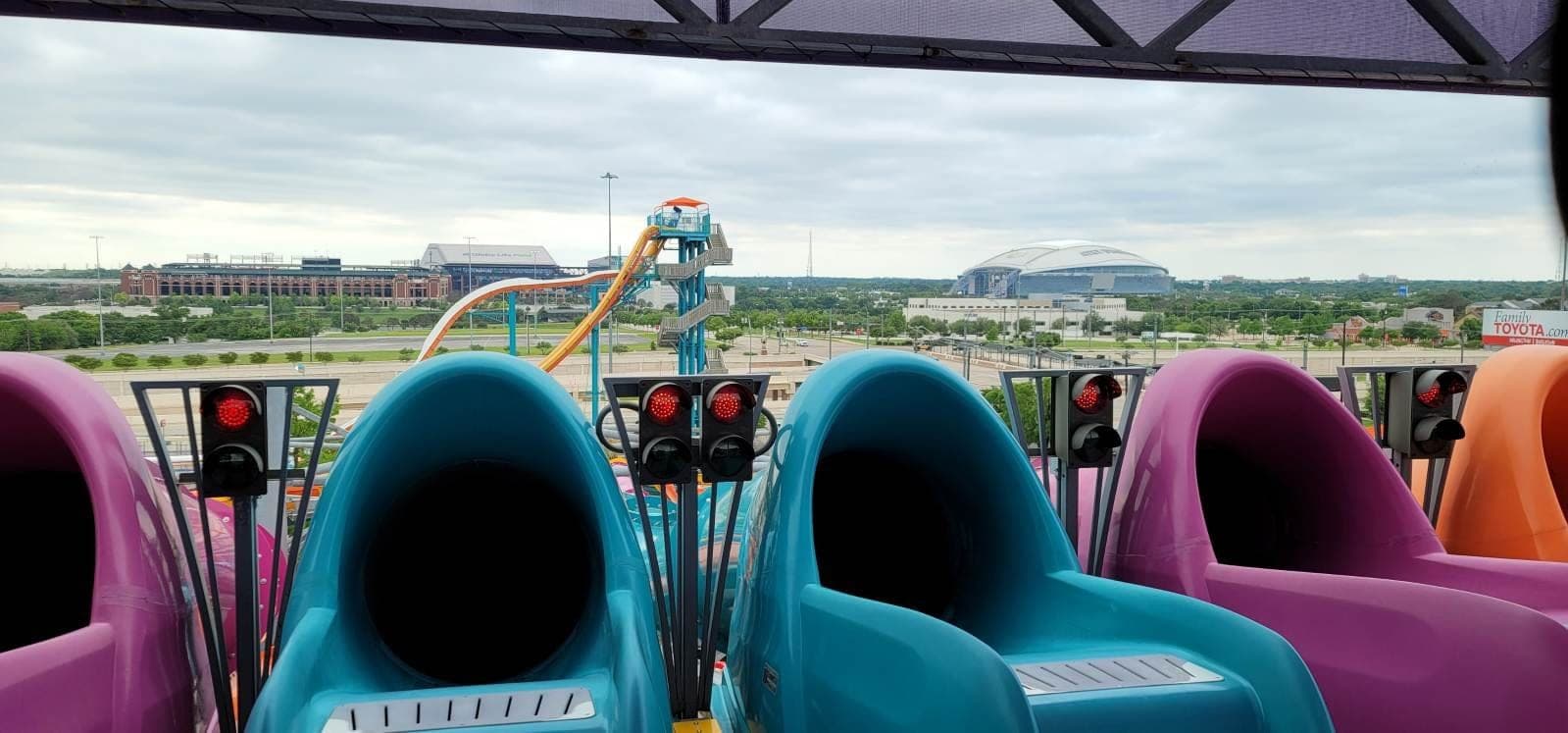 Ride restraint railings at Hurricane Harbor with the Arlington sports stadiums in the background